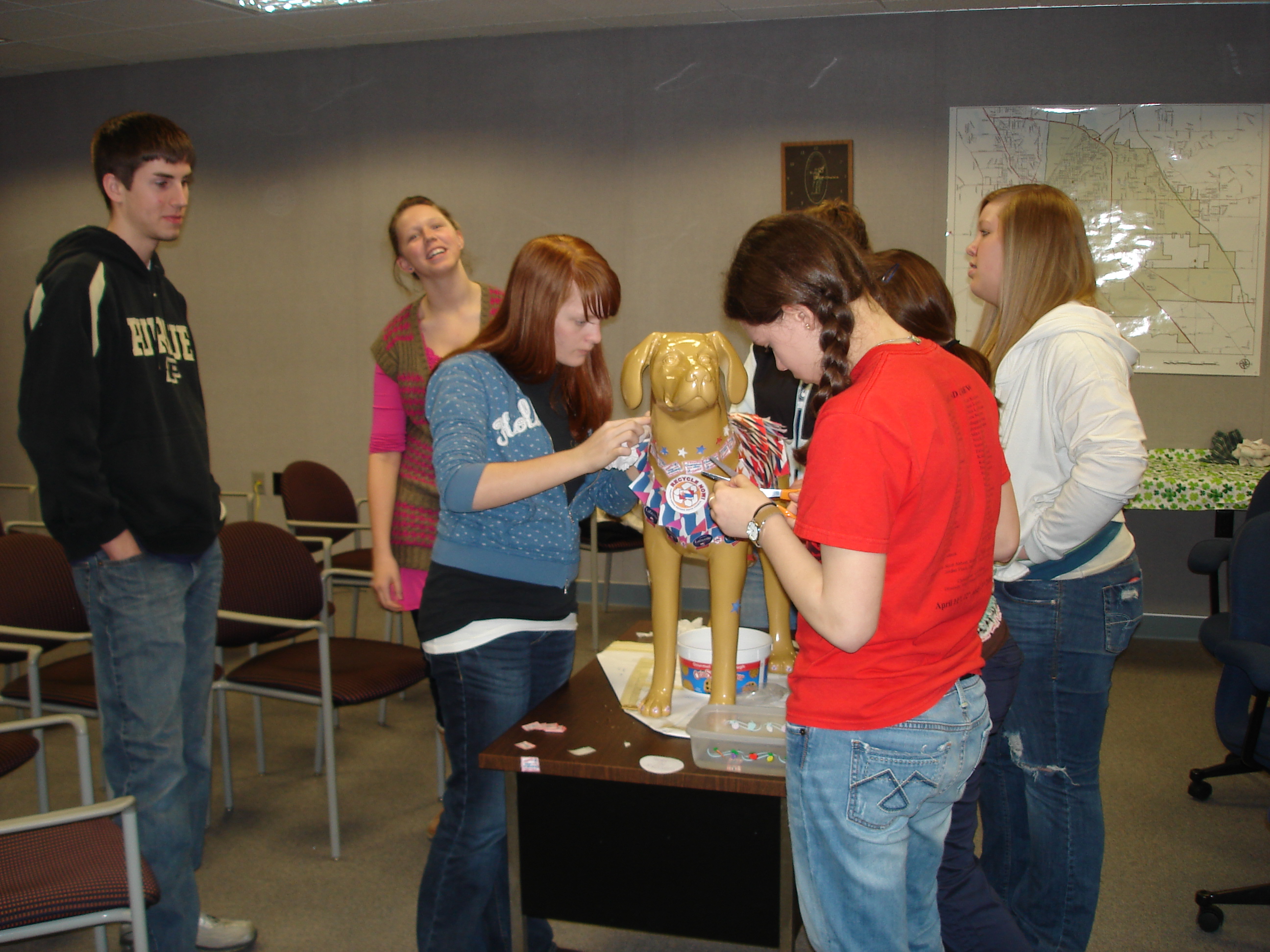 Teens decorating a fake dog